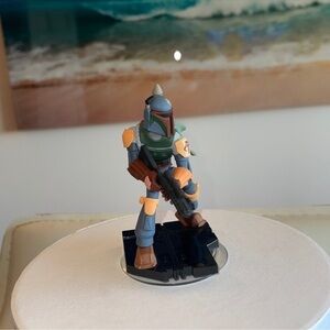 Action Figure on Blue Toy Car